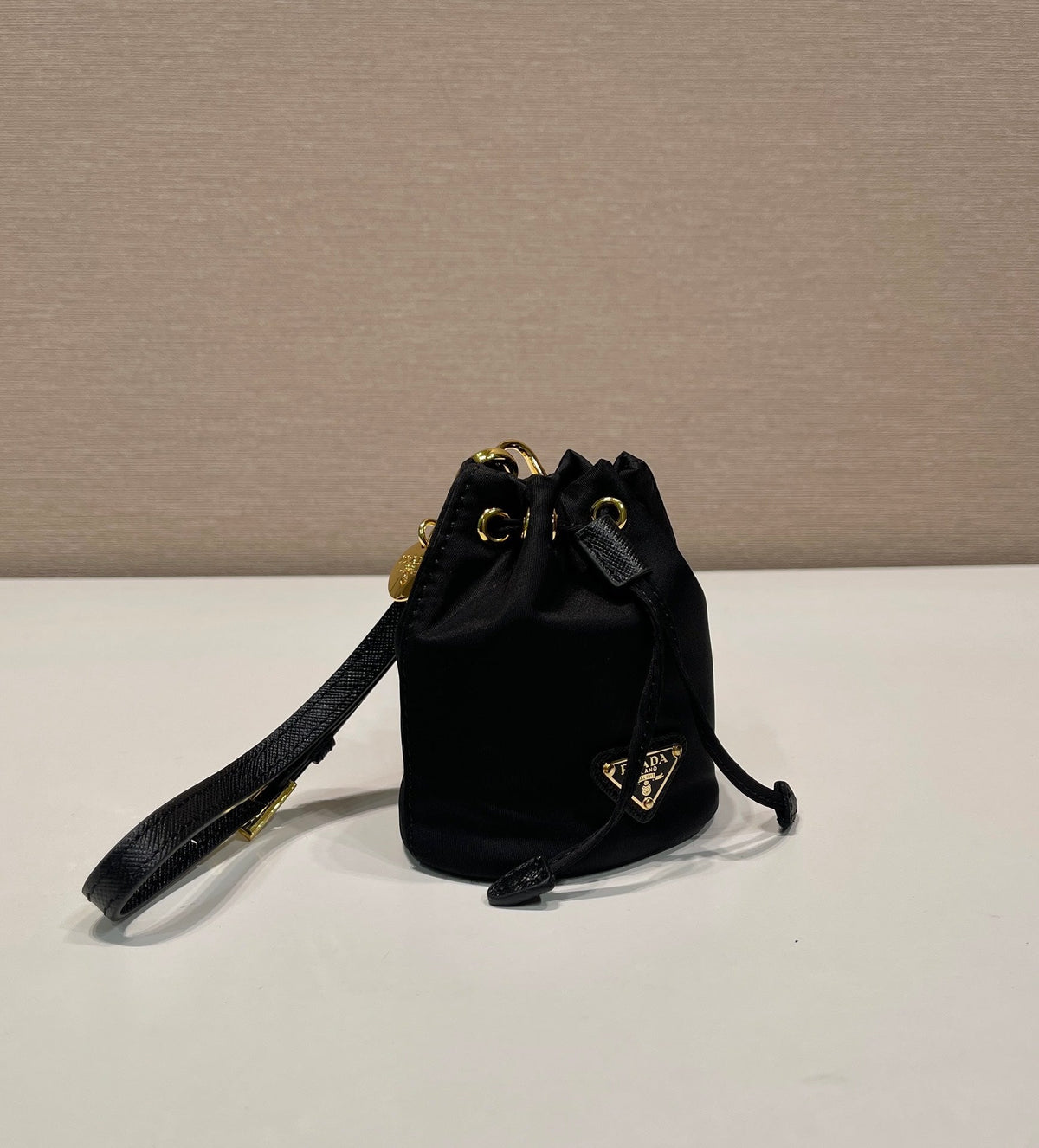MINI BUCKET BAG 10 IN BLACK RE-NYLON AND SAFFIANO LEATHER STRAP