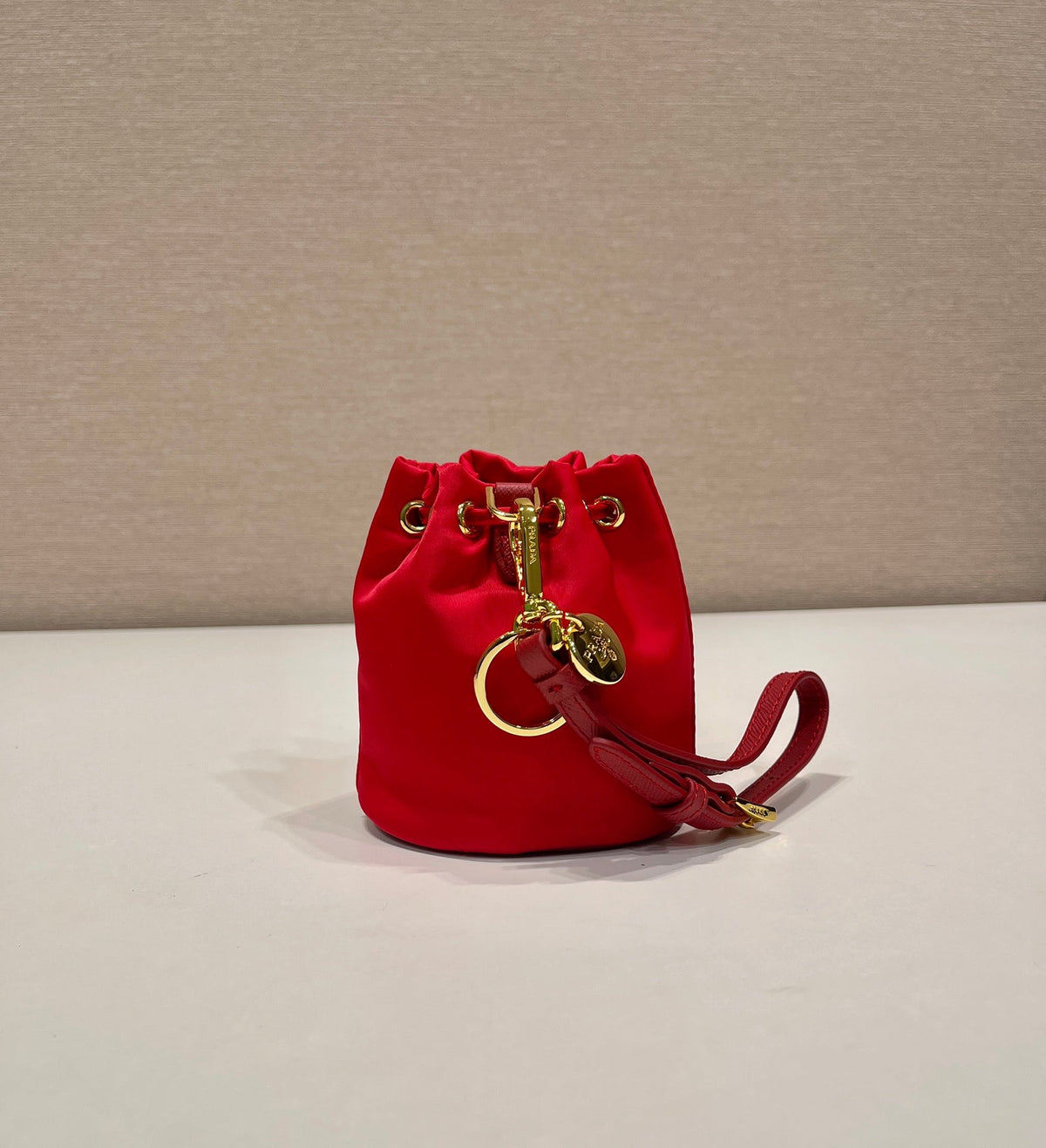 MINI BUCKET BAG 10 IN RED RE-NYLON AND SAFFIANO LEATHER STRAP