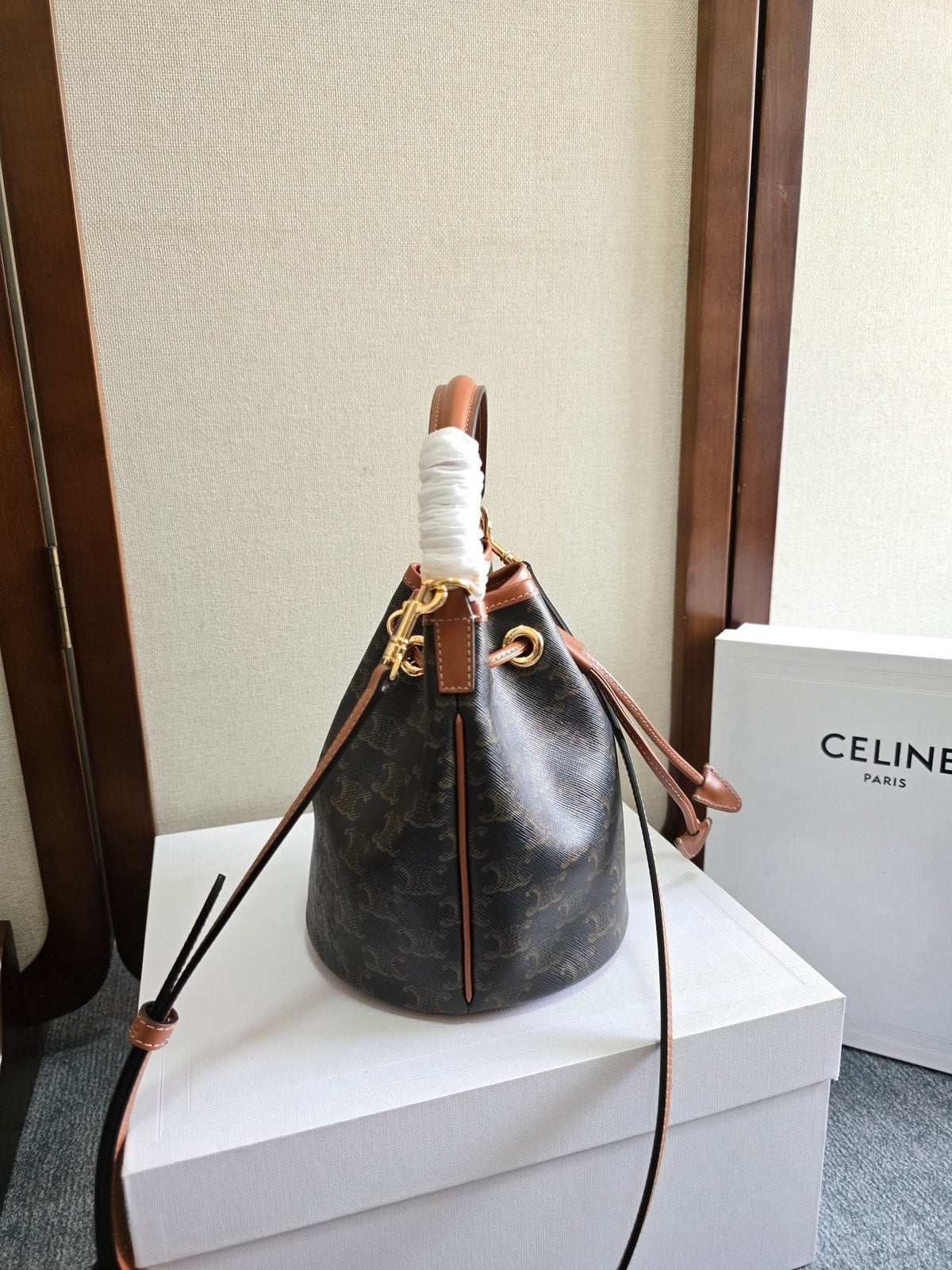 CLARA BAG 19 IN BLACK TRIOMPHE CANVAS AND BROWN CALFSKIN TRIM