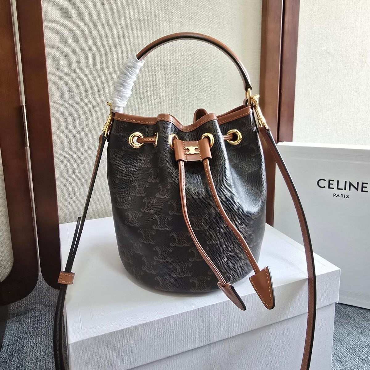 CLARA BAG 19 IN BLACK TRIOMPHE CANVAS AND BROWN CALFSKIN TRIM